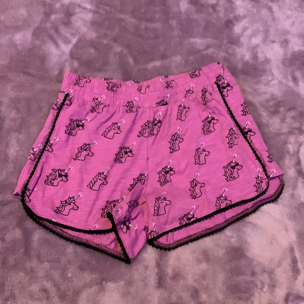 Purple Justice shorts with unicorns on them and black trim. Size (8) girls